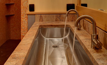 Bathroom with granite sink and glass tile